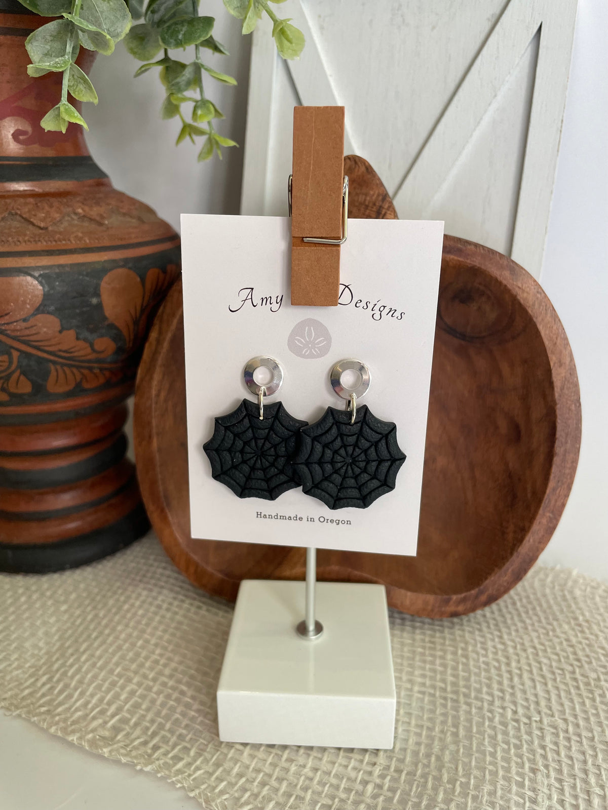 Large black spiderweb/small white stud spiderwebs